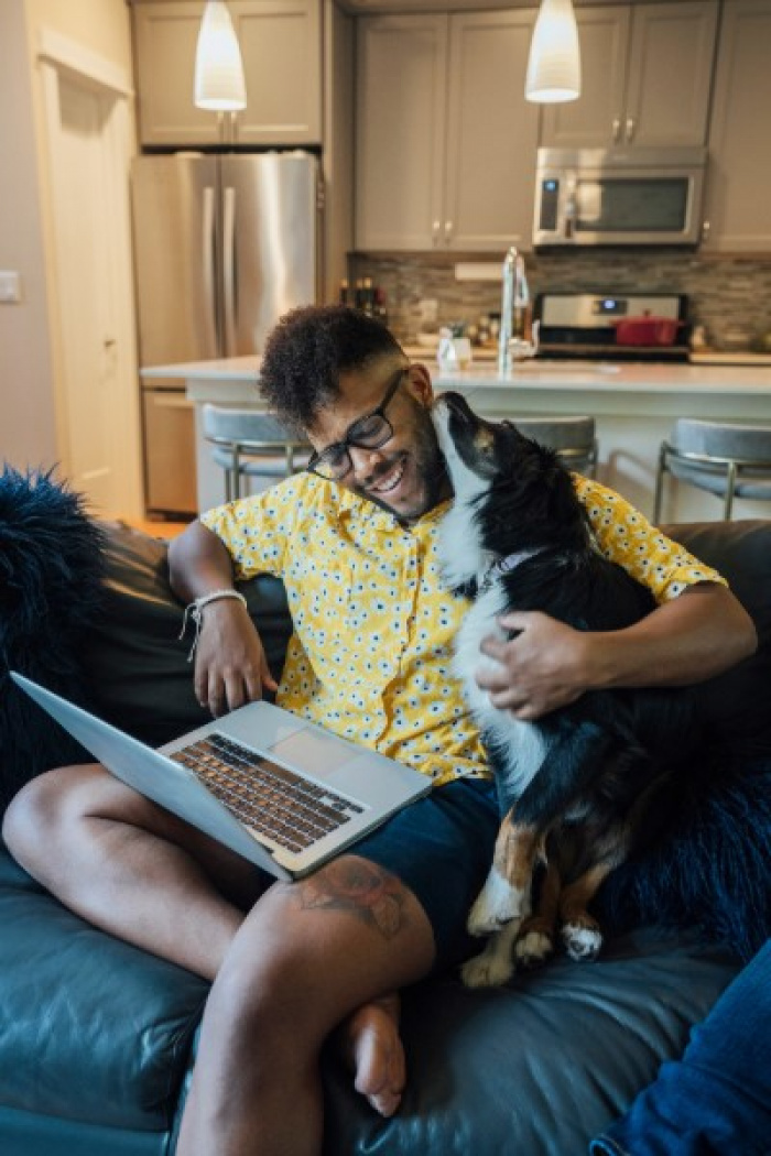 Young man and dog at home