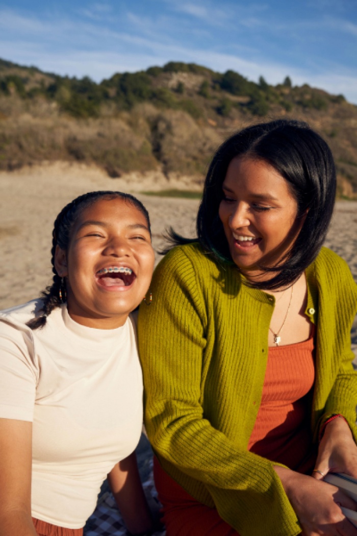 Indigenous mother and daughter laughing