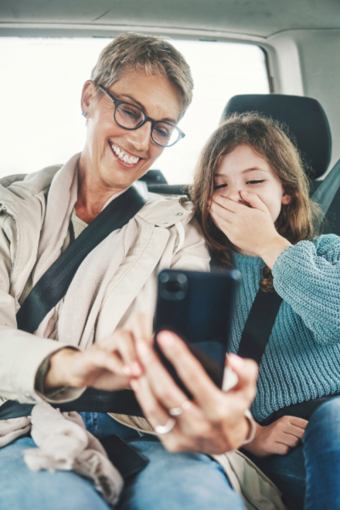 Mother and daughter looking at mobile phone
