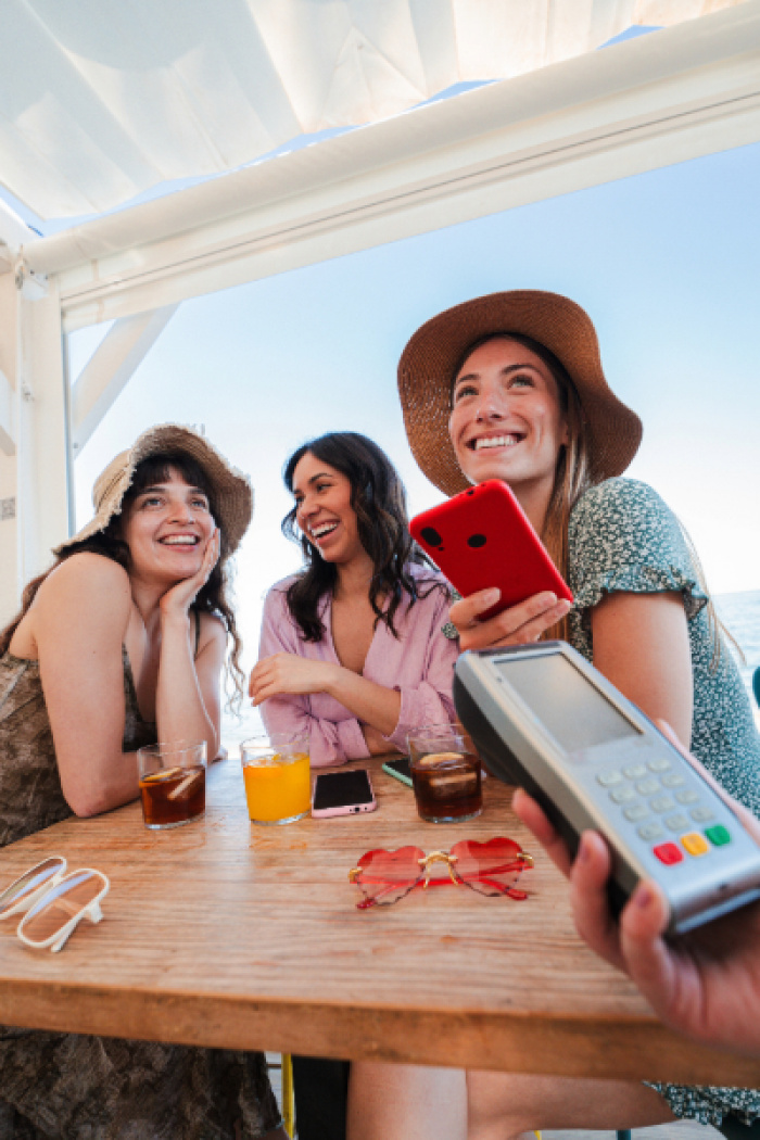 Women paying for brunch with mobile pay