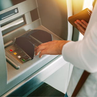 Person using an automated teller machine.