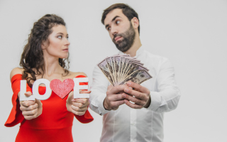 couple looking at each other woman holding a sign that says love and man holding 50 dollar bills